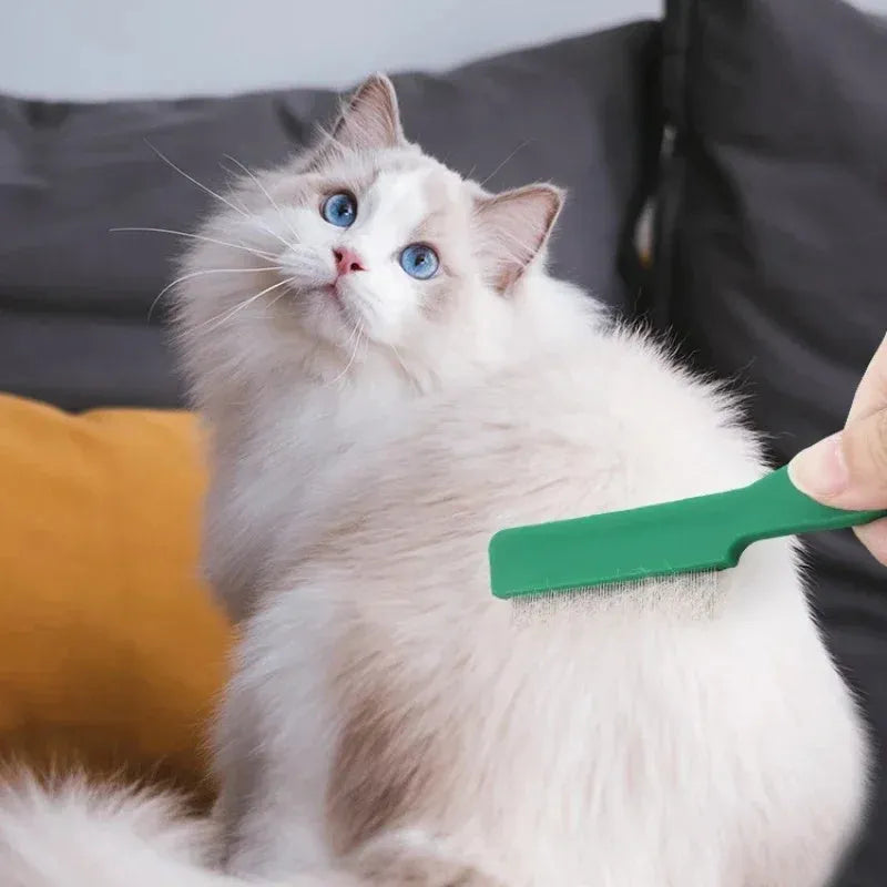 Green plastic handle flea comb with stainless steel pins for dogs and cats, shown next to a ruler indicating 129mm length.