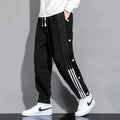 Men's black loose sports sweatpants with ankle ties and elastic high waist