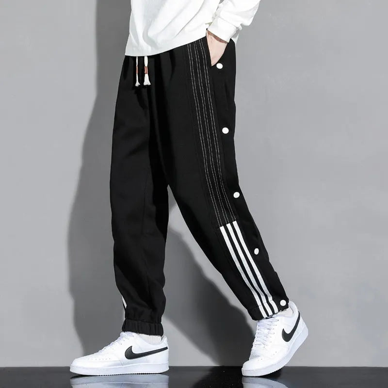 Men's black loose sports sweatpants with ankle ties and elastic high waist