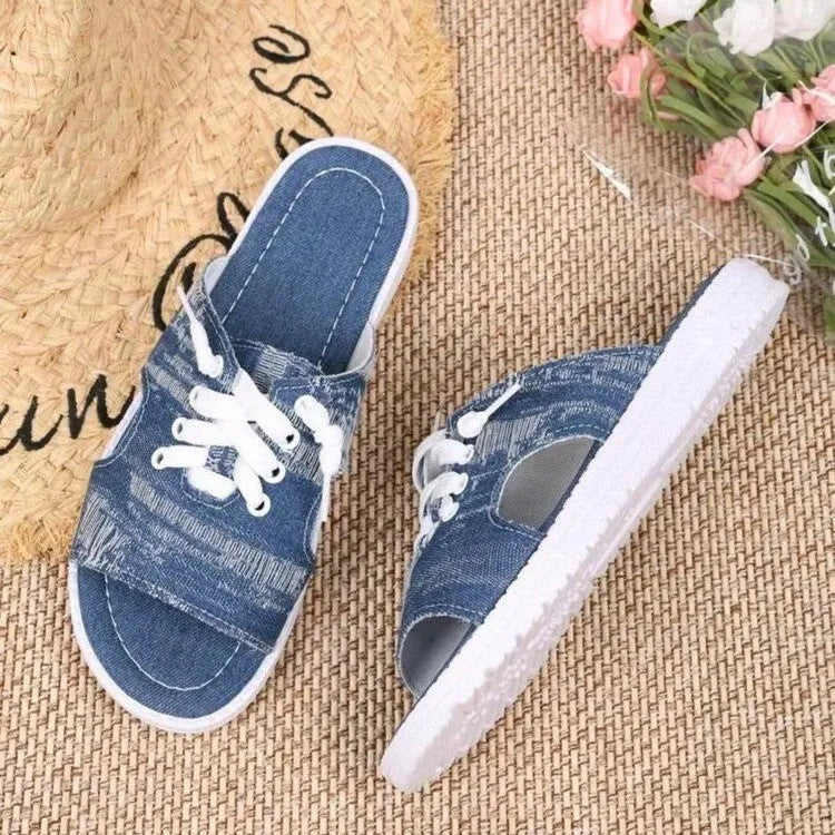 Blue women's Roman style canvas slippers with a flat rubber sole on a white background.