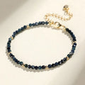 Close-up of a blue tourmaline bracelet with 3mm cut beads and spacer beads.