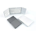 Black mini tri-fold Bluetooth keyboard shown open and folded, highlighting its thin 0.8cm profile.