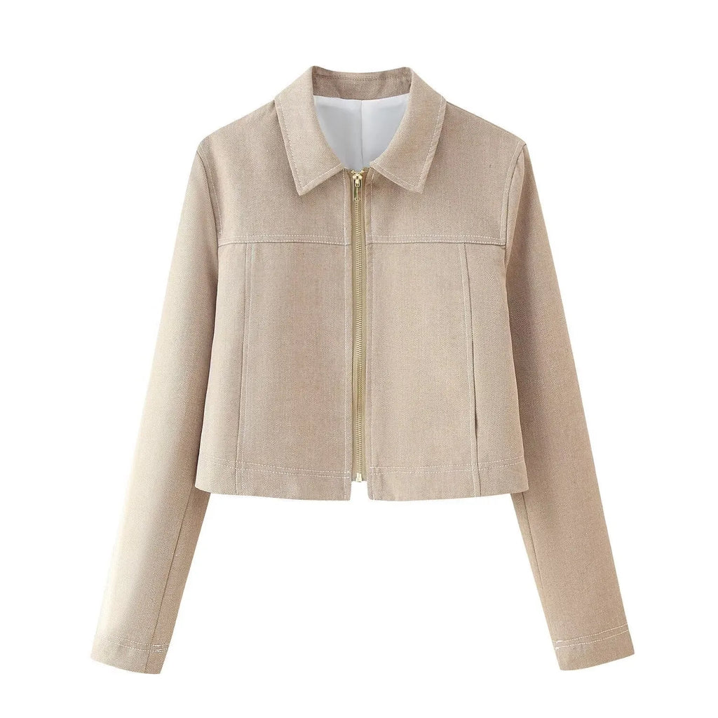 Women's grey herringbone pattern suit with long sleeve coat and straight-leg trousers, showing embroidery detail.