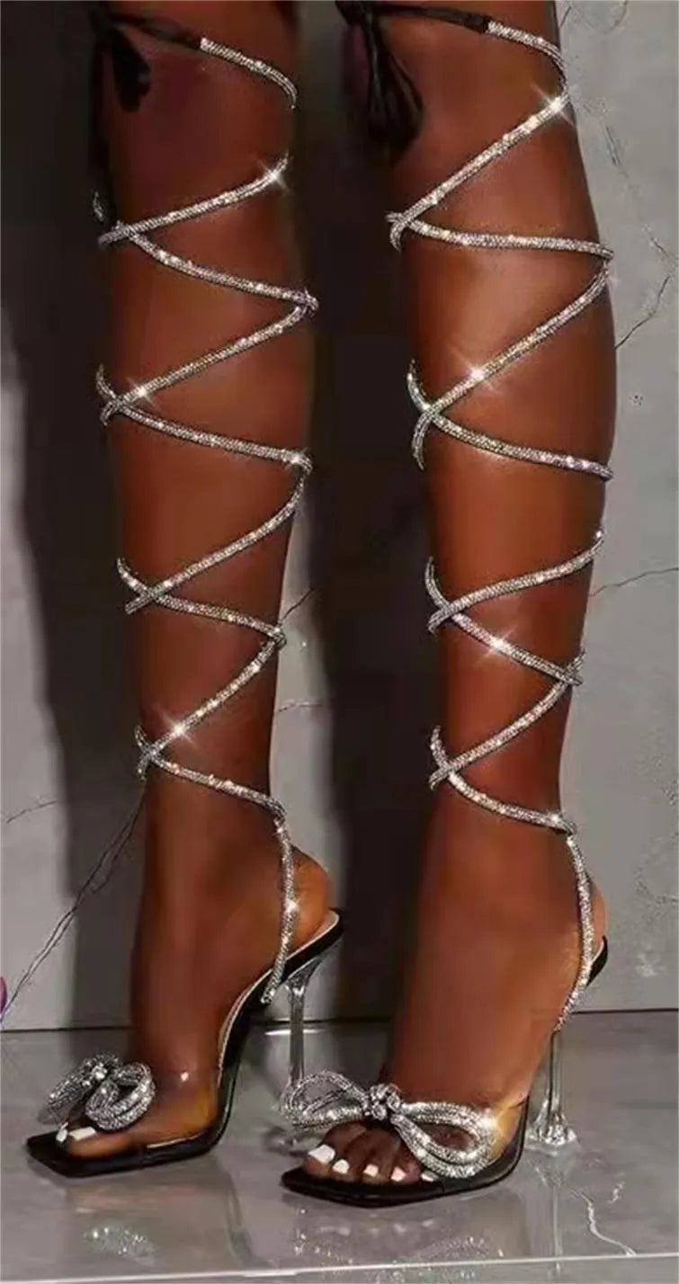 Plus size women's black strappy sandals with rhinestone detailing on Roman-style straps and a square toe