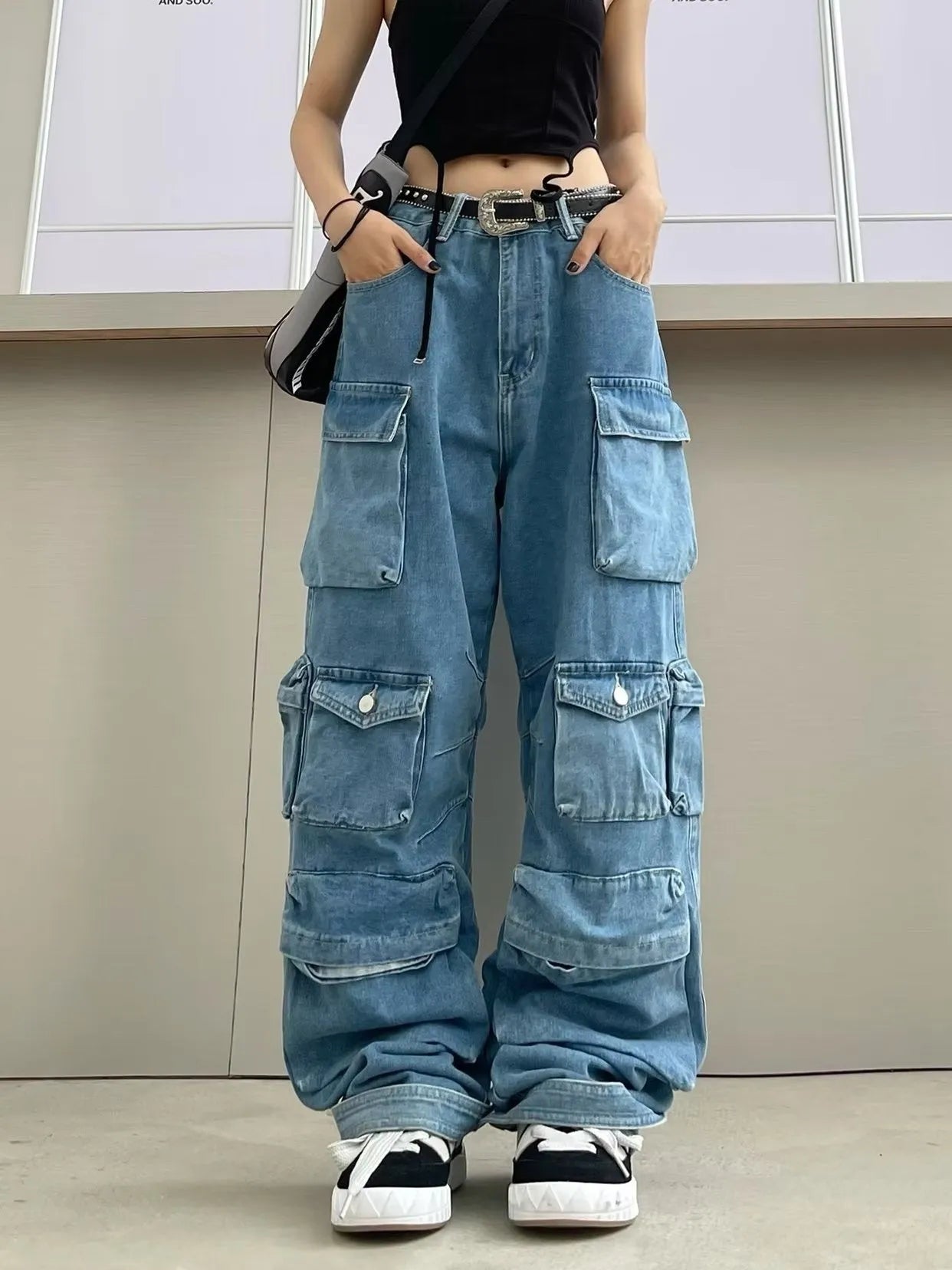 Blue tie-dye women's high waist wide leg denim trousers with multiple pockets on a mannequin.