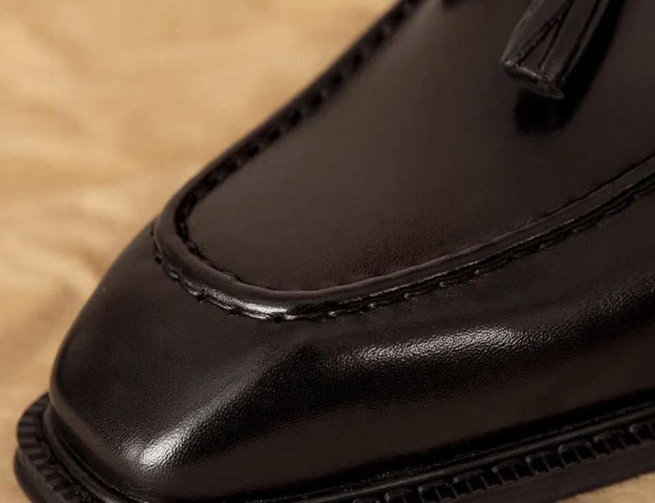 Men's black genuine leather loafers with fringe detailing and slip-on design