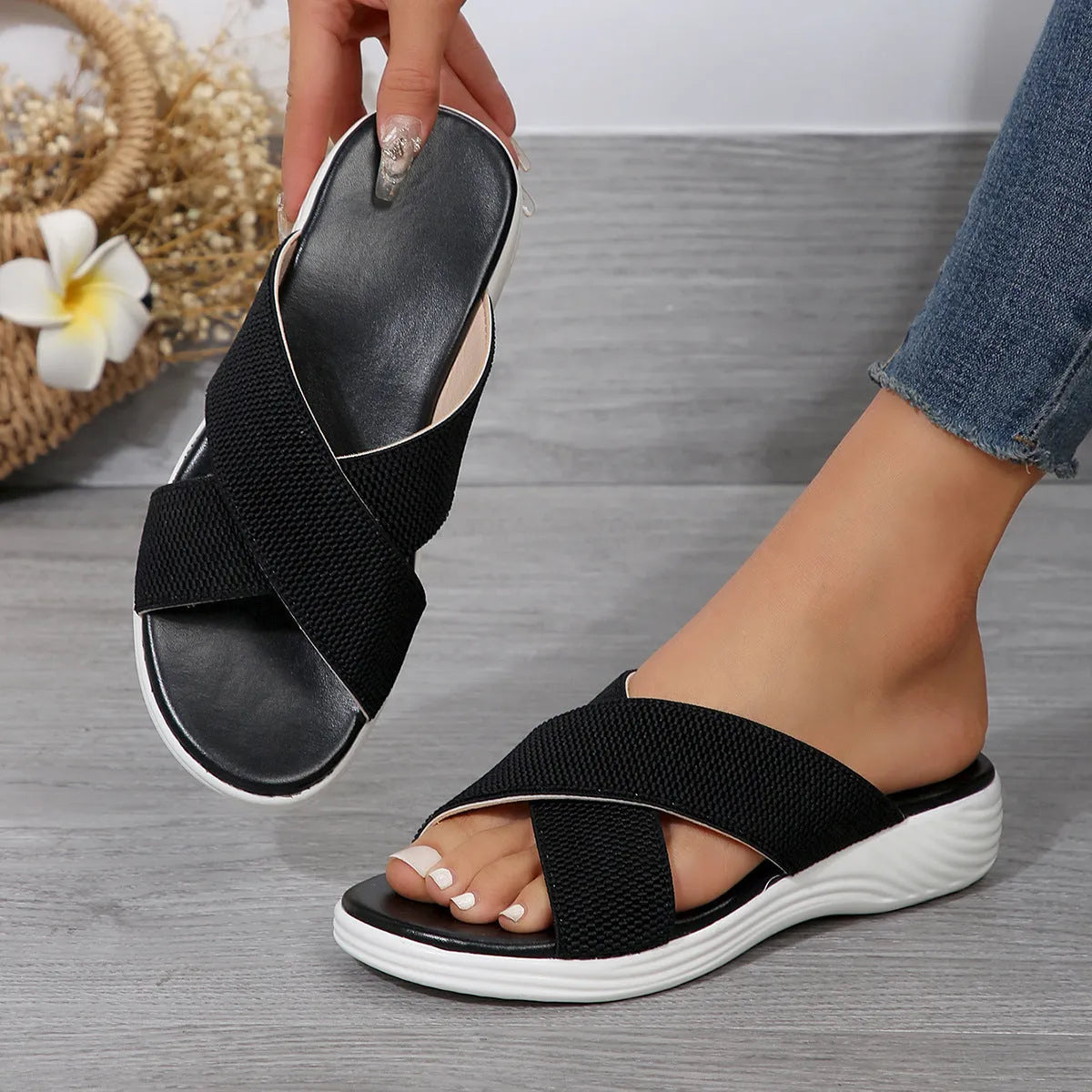 Women's black peep-toe wedge slippers with a thick rubber sole and fish mouth design on a white background.