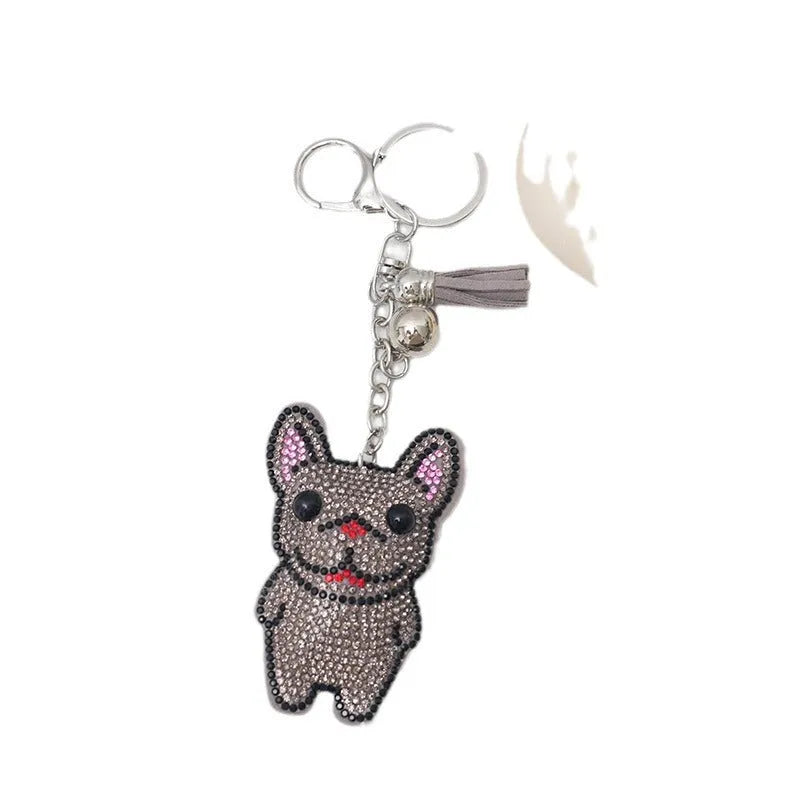 Close-up of a sparkling rhinestone French dog animal keychain charm in caramel colour.