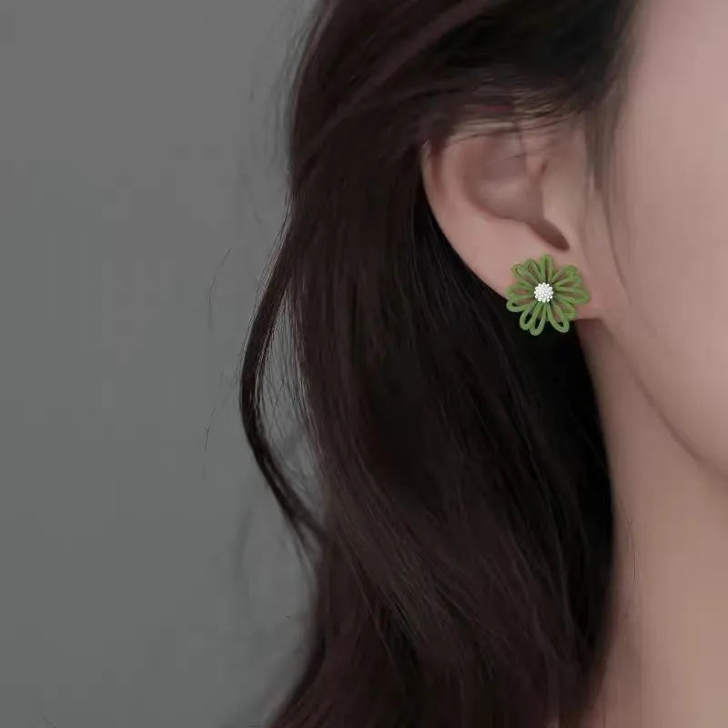 Cartoon flower alloy stud earrings in blue and orange, white and green, or yellow and white two-tone colours