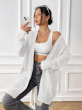 Women's double pocket cardigan in acrylic fabric showing loose fit and 65cm length