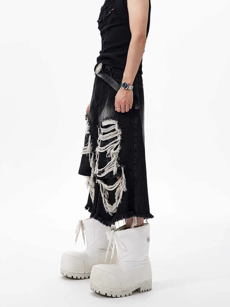 Black wide-leg cropped jeans with ripped patch detailing and mid-high waist