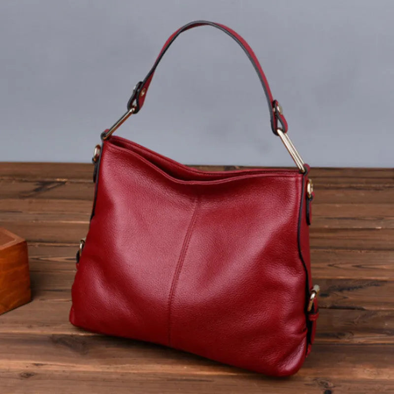 Genuine leather vertical square crossbody bag showing multiple internal pockets including a zipper changing bag and mobile phone pocket.