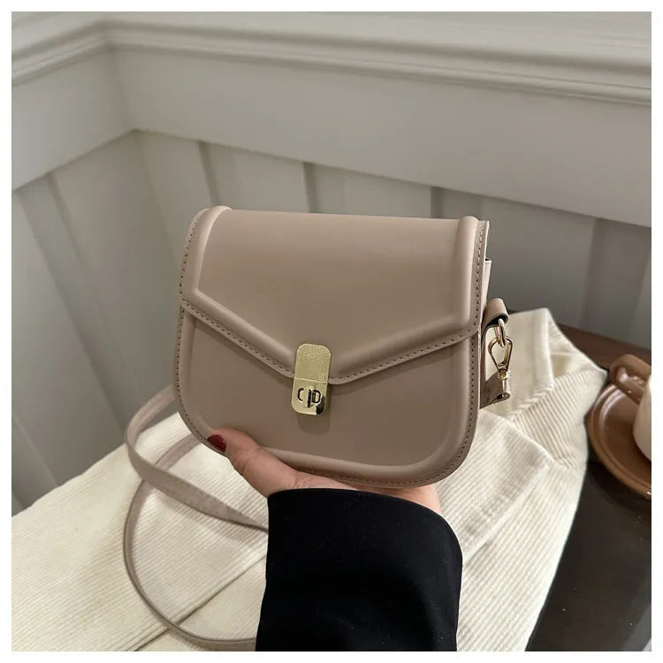 PU leather soft shell messenger bag with clamshell opening in a horizontal square shape.