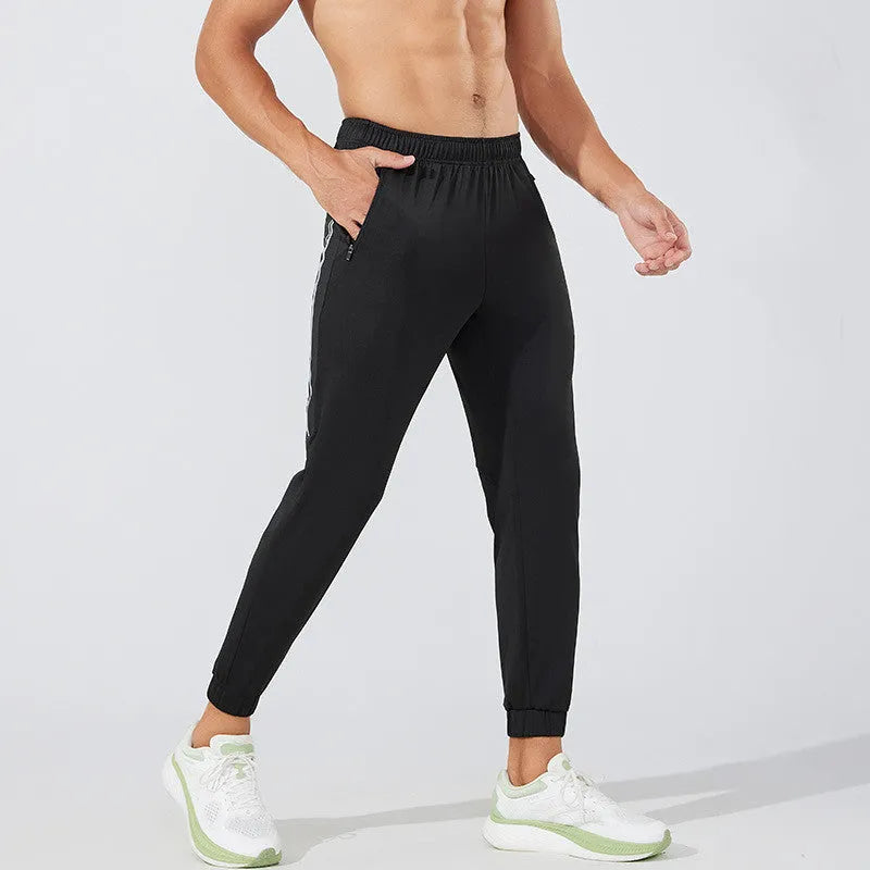 Men's black running trousers in polyester fabric with trousers-length legs for spring exercise