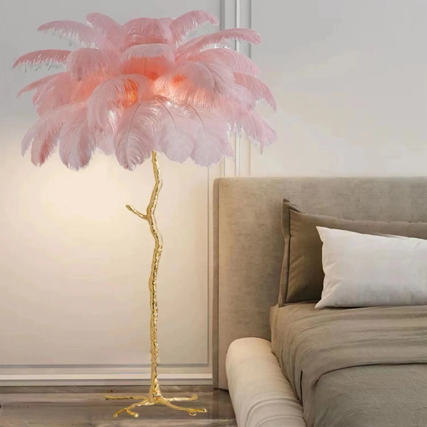 Tall decorative floor lamp with a cluster of white resin feathers next to a sofa.