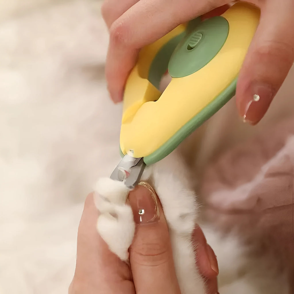 Green professional pet nail clipper with LED light on, showing safety guard and ergonomic handle.