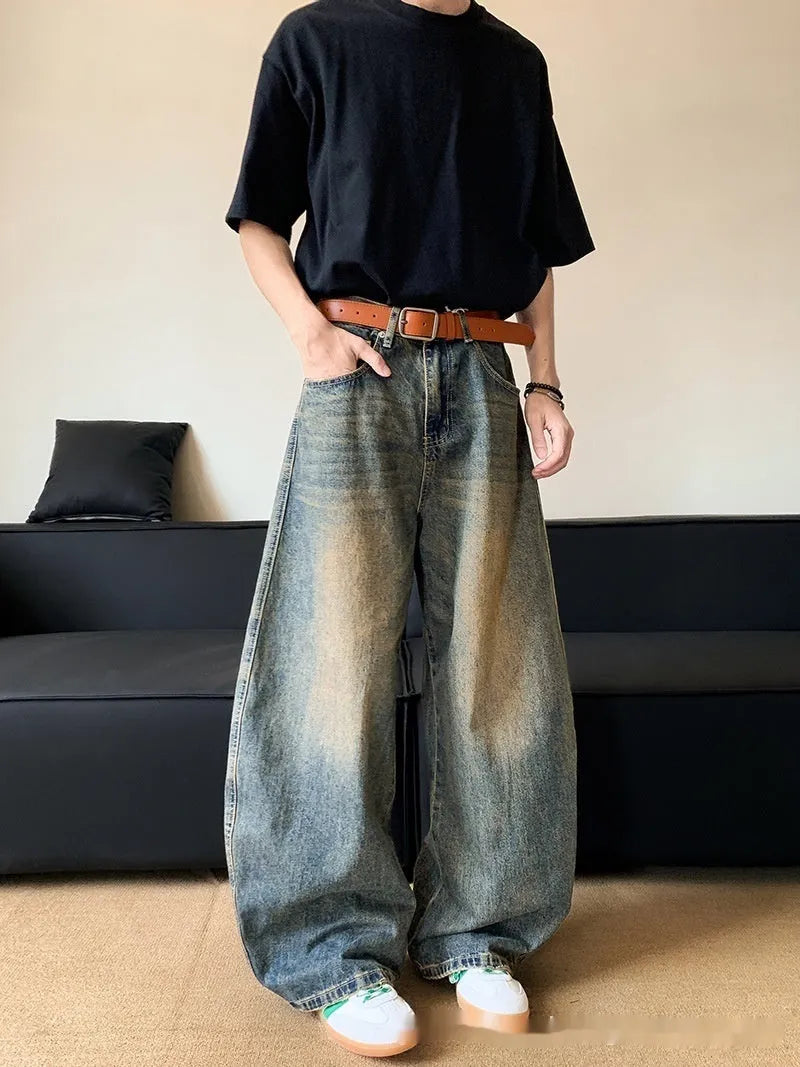 Men's retro blue distressed wide-leg jeans with a slimming fit through hips and thighs.