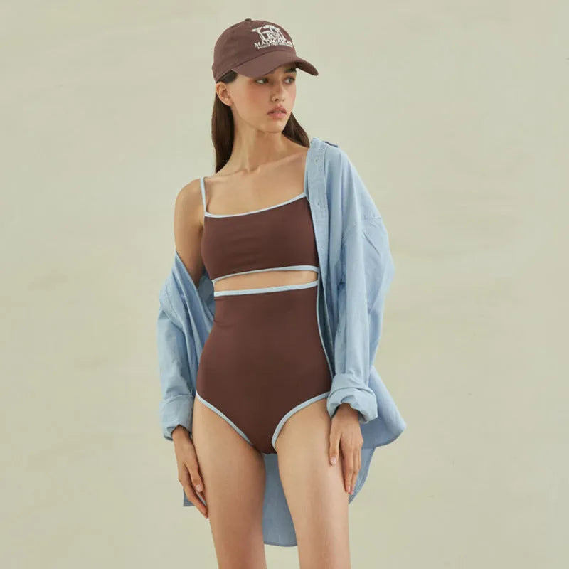 Brown women's one-piece swimsuit with triangle bust style on a mannequin.