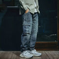 Man wearing blue loose straight-leg retro style stretch denim casual trousers