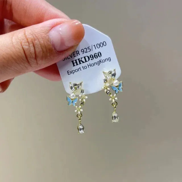 Geometric heart-shaped women's alloy earrings with rhinestones and a tassel, shown in stud and clip-on styles.