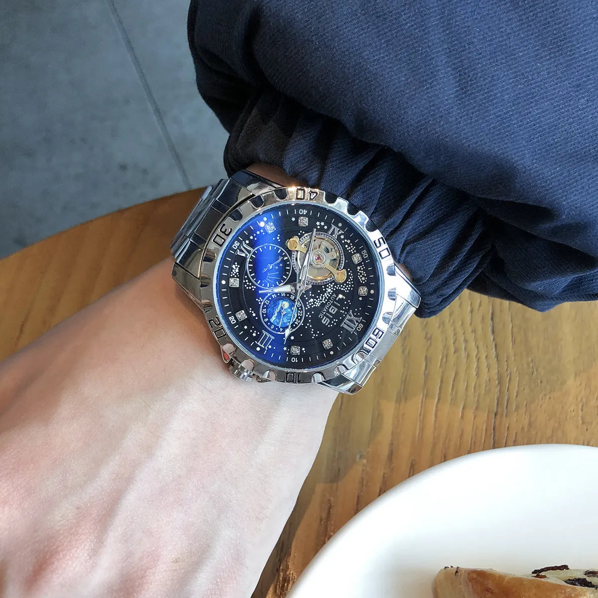 Men's silver case automatic watch with black leather strap and luminous starry dial