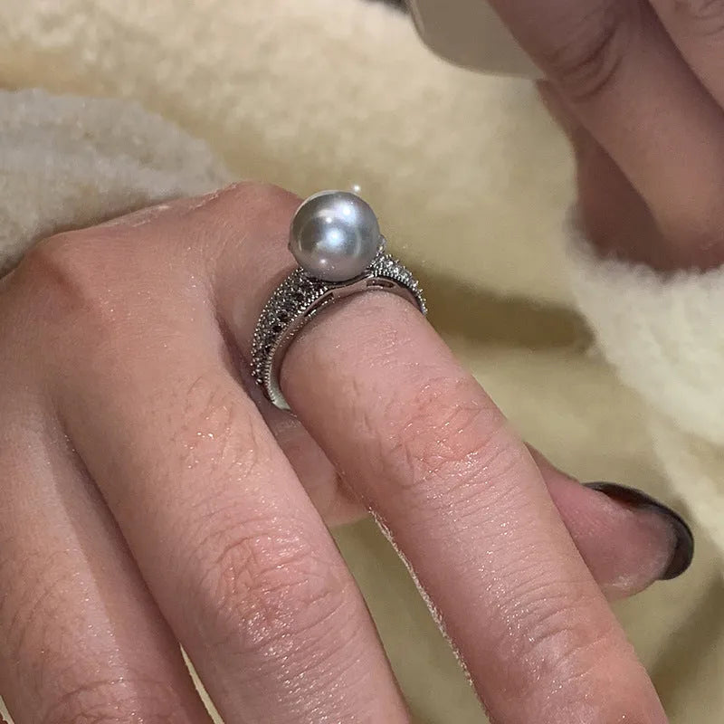 Adjustable copper geometric ring with black pearl detail on open-ended design