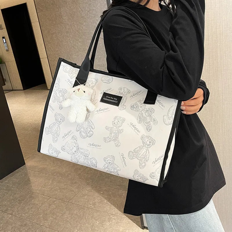 Women's canvas tote bag with printed rhombus pattern in black colour with pendant attachment