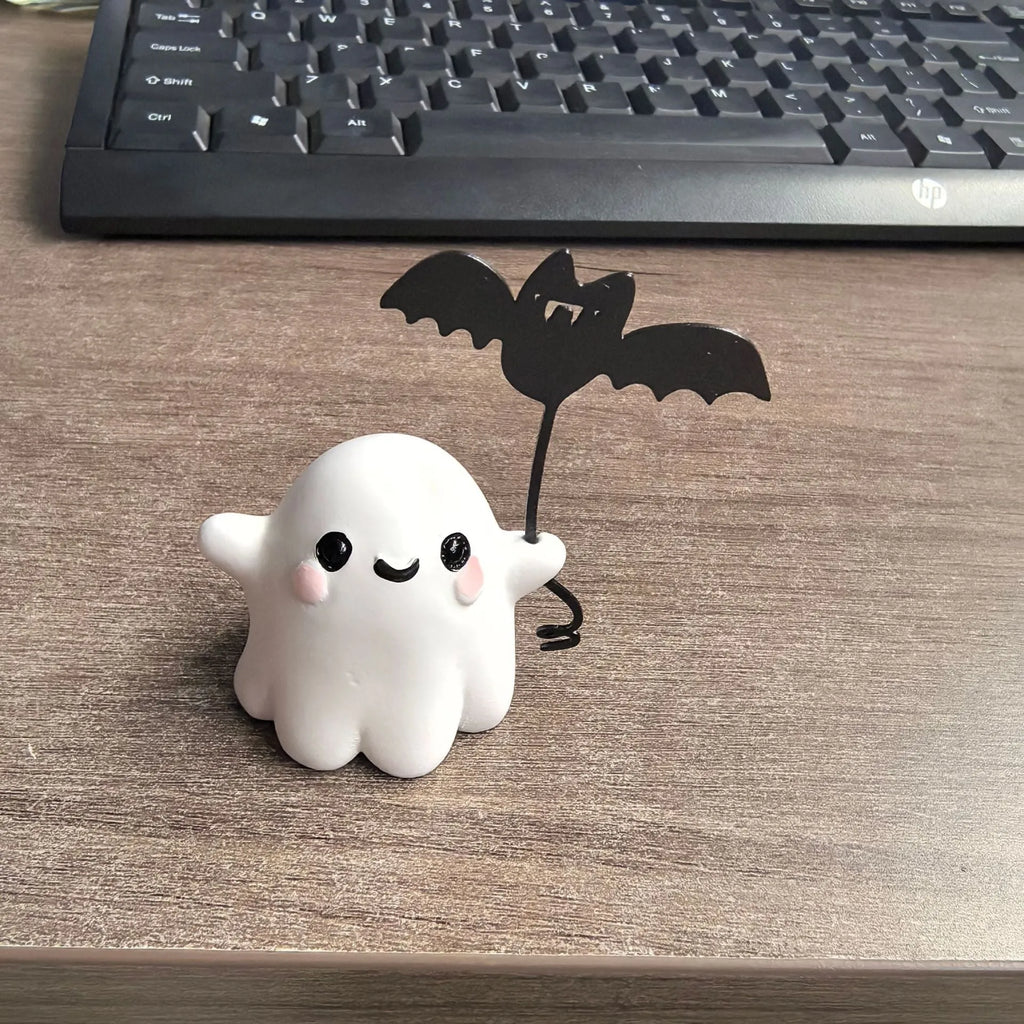 Miniature resin ghost statue walking a dog and holding a bat, Halloween decoration