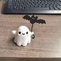 Miniature resin ghost statue walking a dog and holding a bat, Halloween decoration