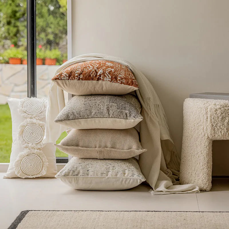 Solid colour decorative cushion on a sofa, showing its square shape and pp cotton filling.