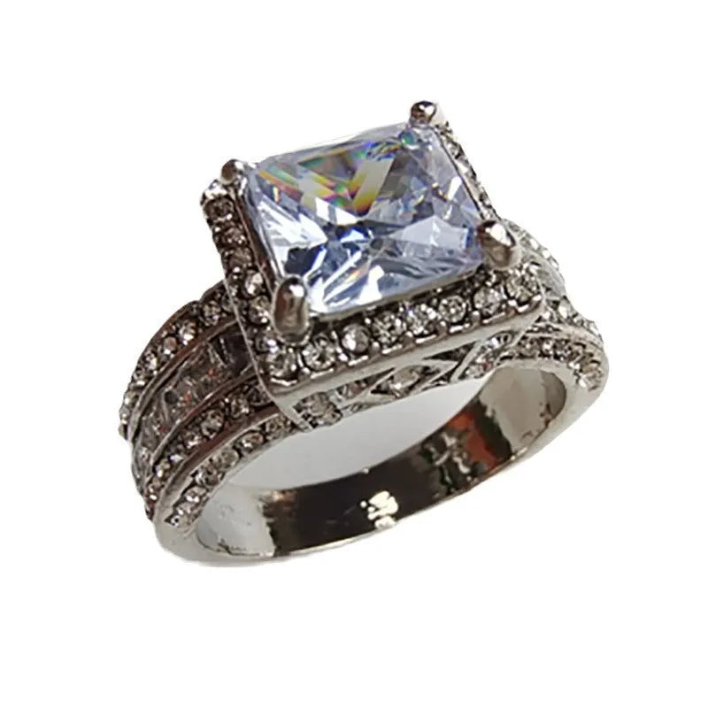 Geometric silver-fashion women's ring in gold or white colour on a grey background.