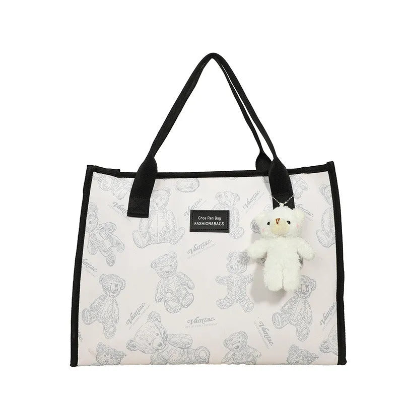 Women's canvas tote bag with printed rhombus pattern in black colour with pendant attachment