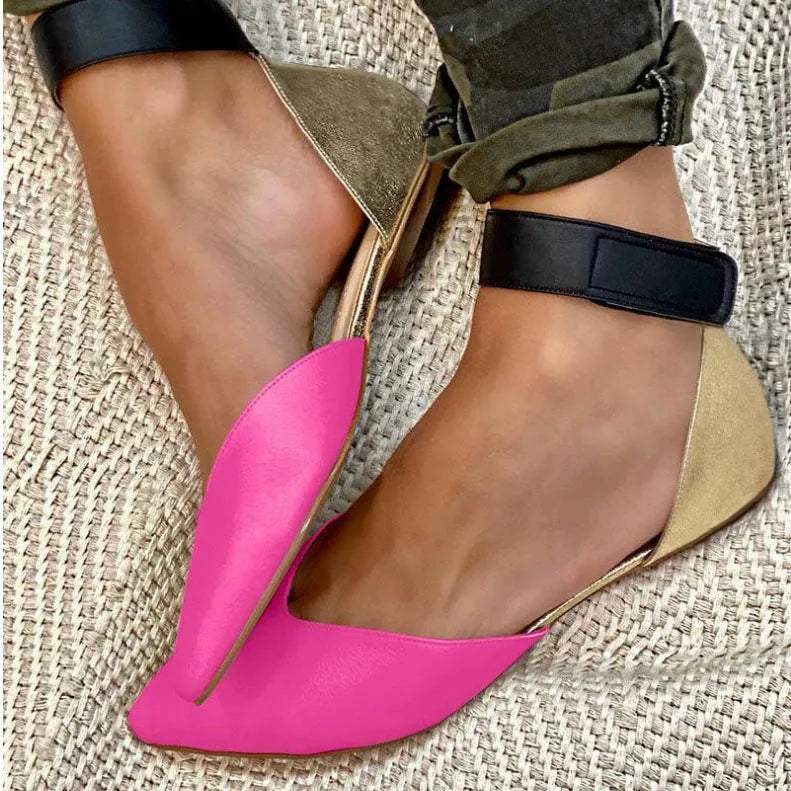 Women's beige flat sandals with a Velcro strap and hollowed PU leather upper on a white background.