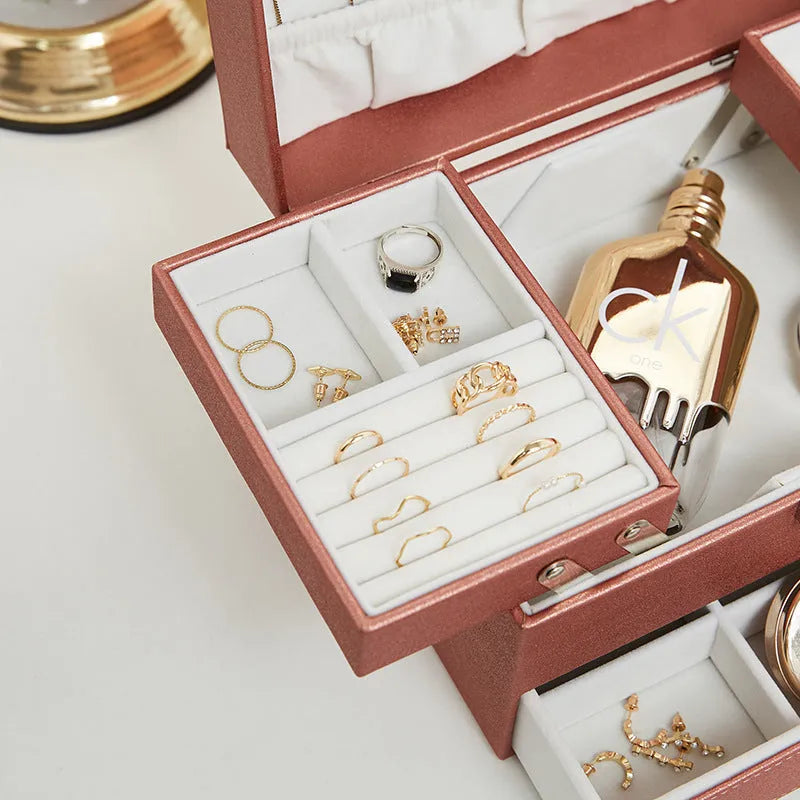 Hard case PU leather jewellery storage box in rose gold colour with dimensions 22.5cm by 15.5cm.