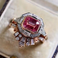 Women's rose gold colour alloy ring with geometric ruby-coloured centrepiece on finger