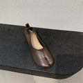 Women's black chunky heel pumps with a rounded toe and split toe horseshoe pea detail.