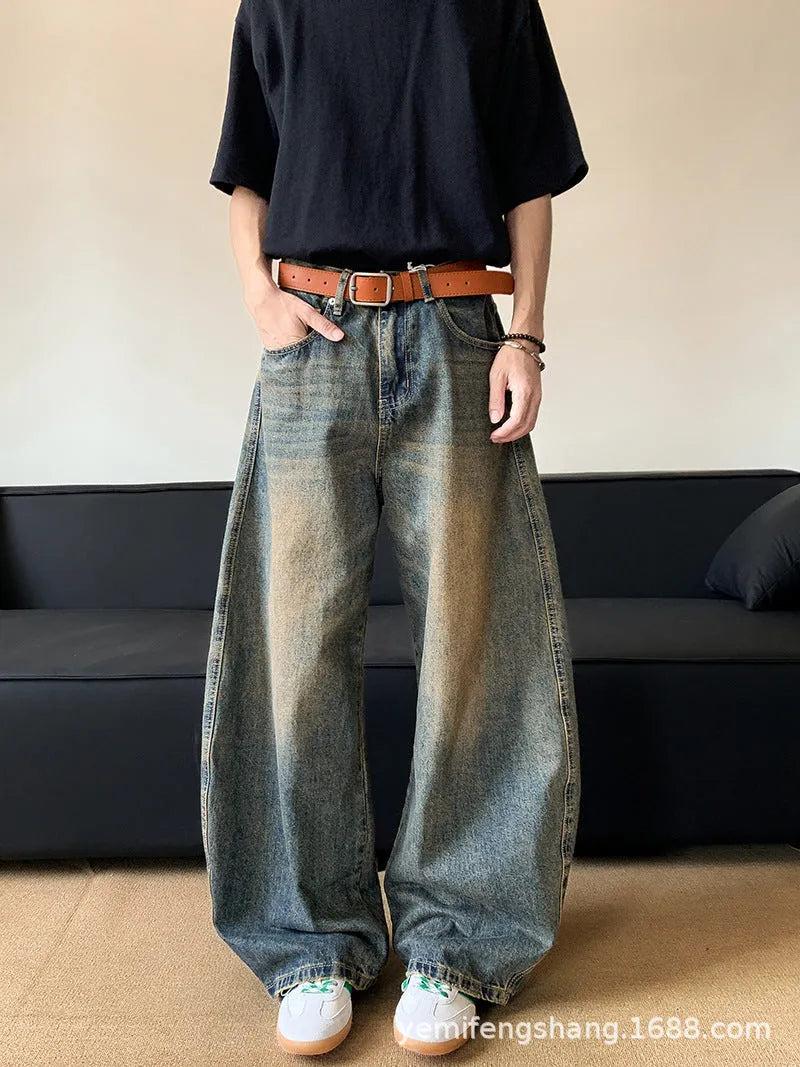 Men's retro blue distressed wide-leg jeans with a slimming fit through hips and thighs.
