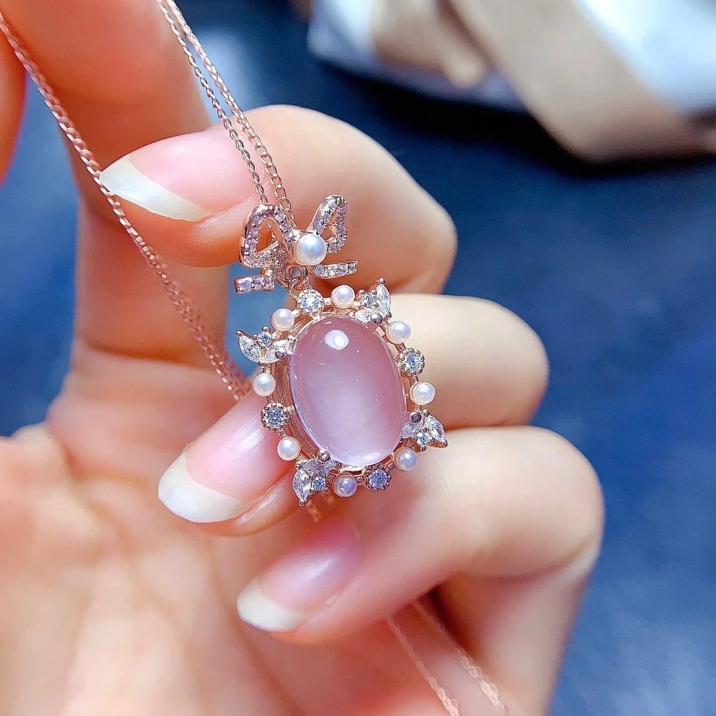 Pink rose quartz crystal pendant on silver necklace with rose gold plating geometric design