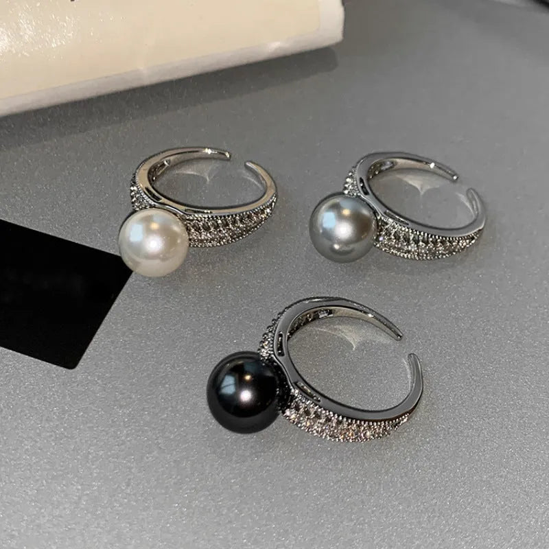 Adjustable copper geometric ring with black pearl detail on open-ended design