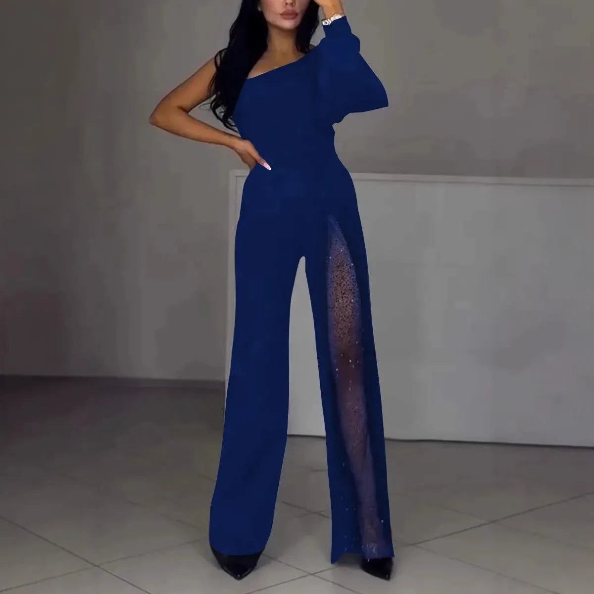 Black oblique shoulder high slit women's long sleeve jumpsuit on a model.