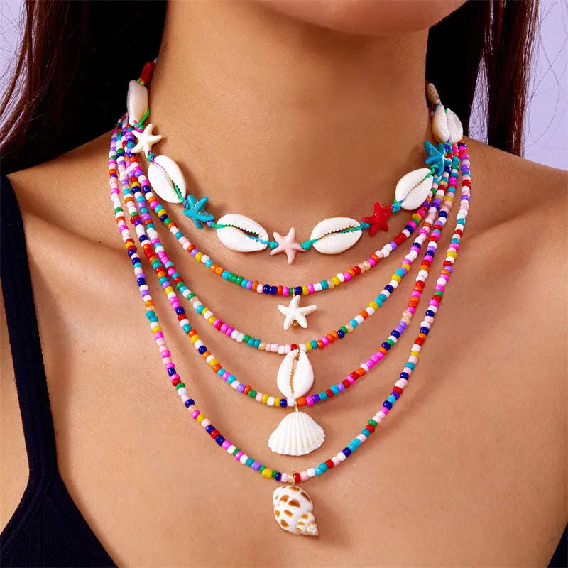 Five multi-layer women's necklaces with shell, starfish and conch beads on adjustable chains