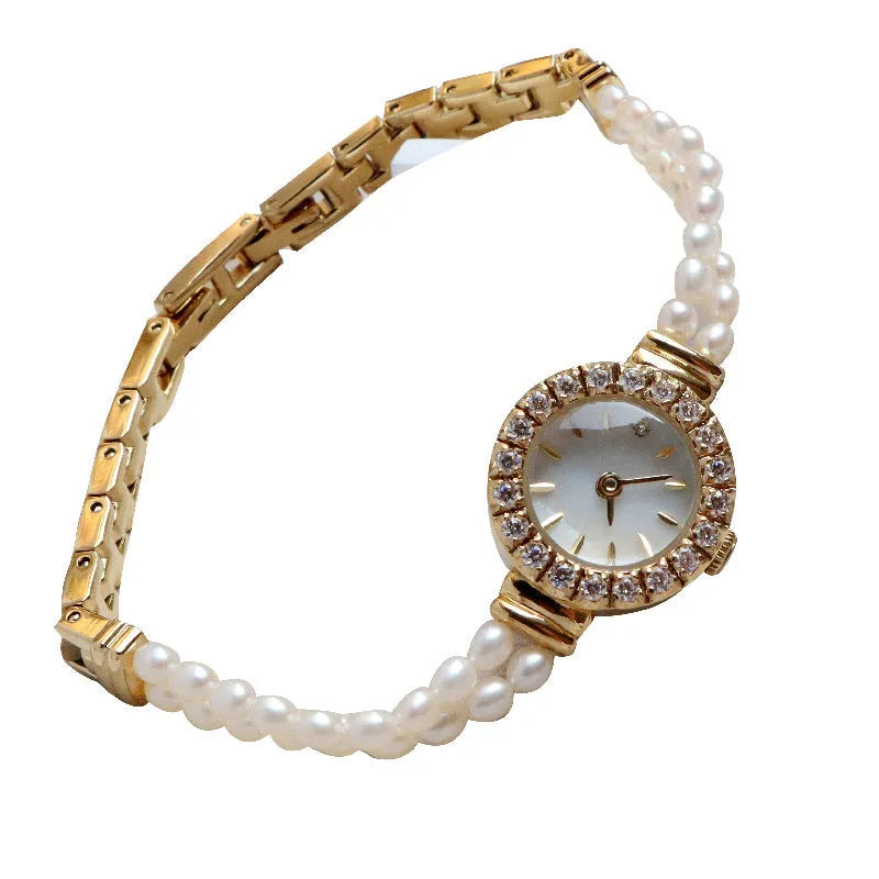 Women's light gold bracelet watch with freshwater pearl band and 18mm round dial