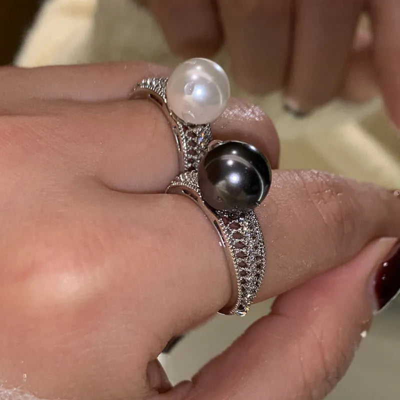 Adjustable copper geometric ring with black pearl detail on open-ended design