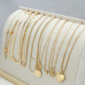 Ten gold electroplated necklaces with alloy pendants on adjustable snake bone chains