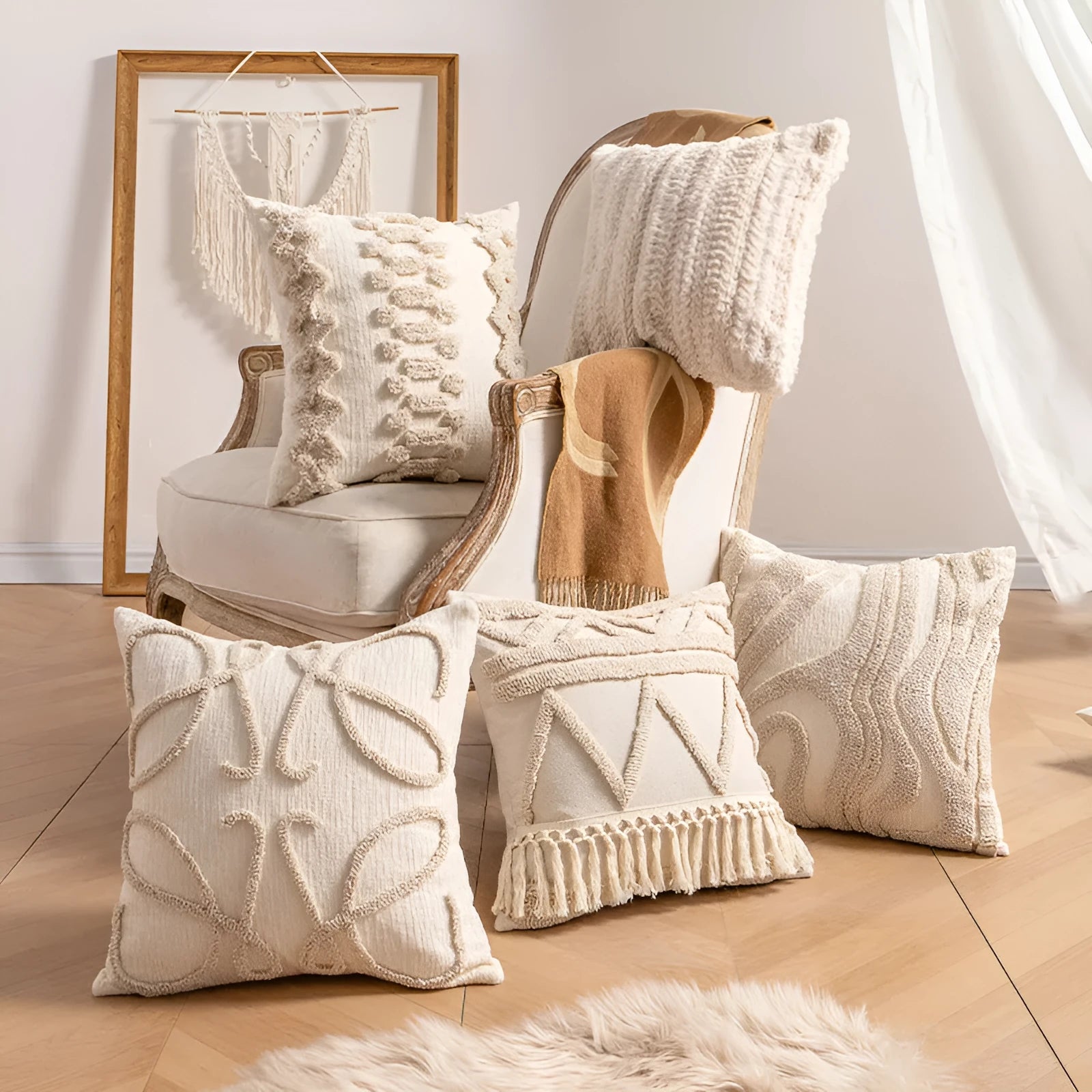 Knitted pillow cover with tassel trim in a spiral dot pattern on a striped background.