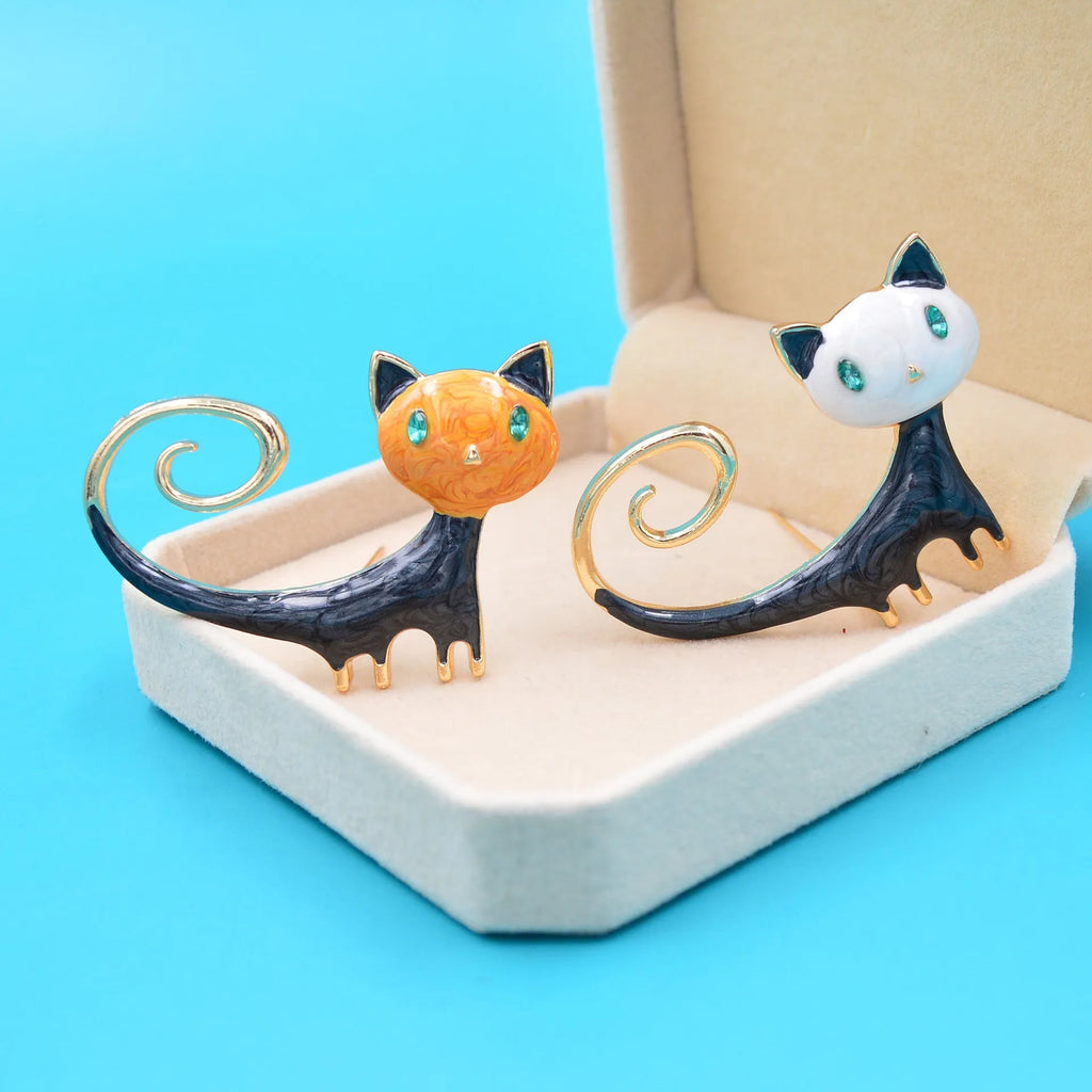 Women's alloy cat brooch with a hand-painted tail, shown in white and orange colour options.