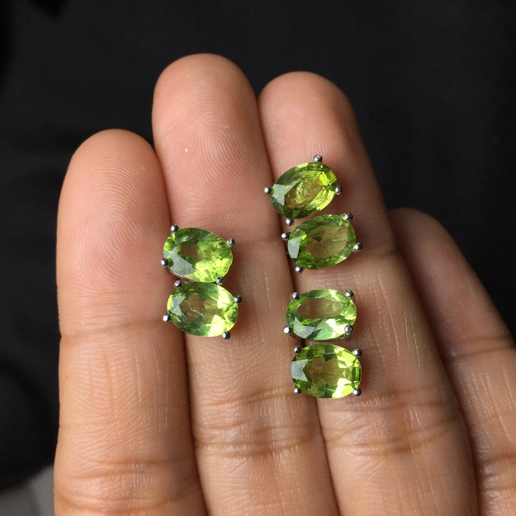 Natural grass green olivine stud earrings in S925 sterling silver with 6×8mm elliptical faceted gemstones.