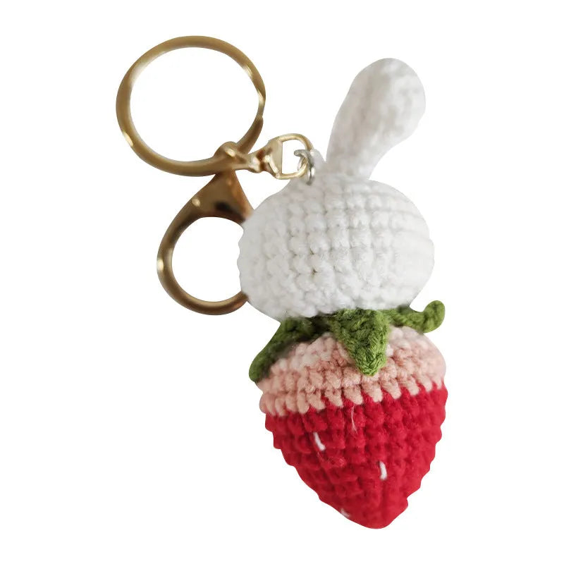 Hand-woven rabbit strawberry wire pendant with key attachment on white background