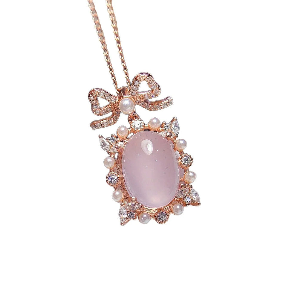 Pink rose quartz crystal pendant on silver necklace with rose gold plating geometric design