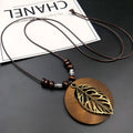 Adjustable wooden leaf necklace with ethnic styling on cotton-linen cord